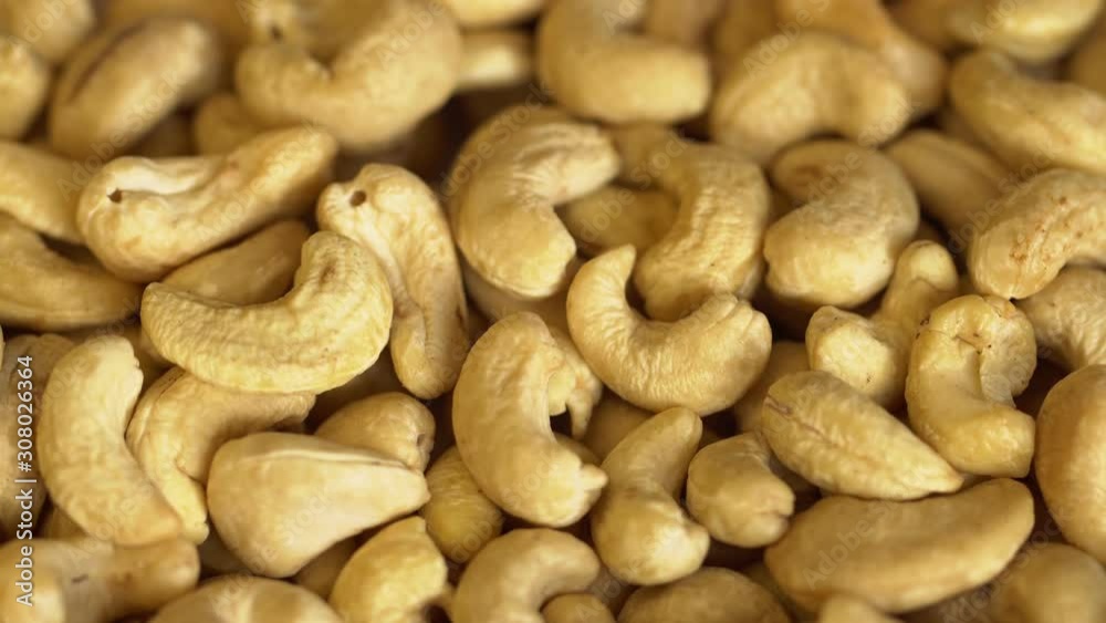 Walnut close up. product rich in minerals and vitamins. Cashew turns in a shot. Cashew kernels rotating. Cashew close up lies under beams of the sun. Macro 4K Walnut close up. product rich in minerals and vitamins. Cashew turns in a shot. Cashew kernels rotating. Cashew close up lies under beams of the sun. Macro 4K