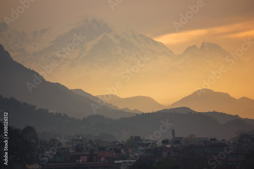 Beautiful dawn light hits the mountains of the Annapurna Range that surround the city of Pokhara in Nepal.