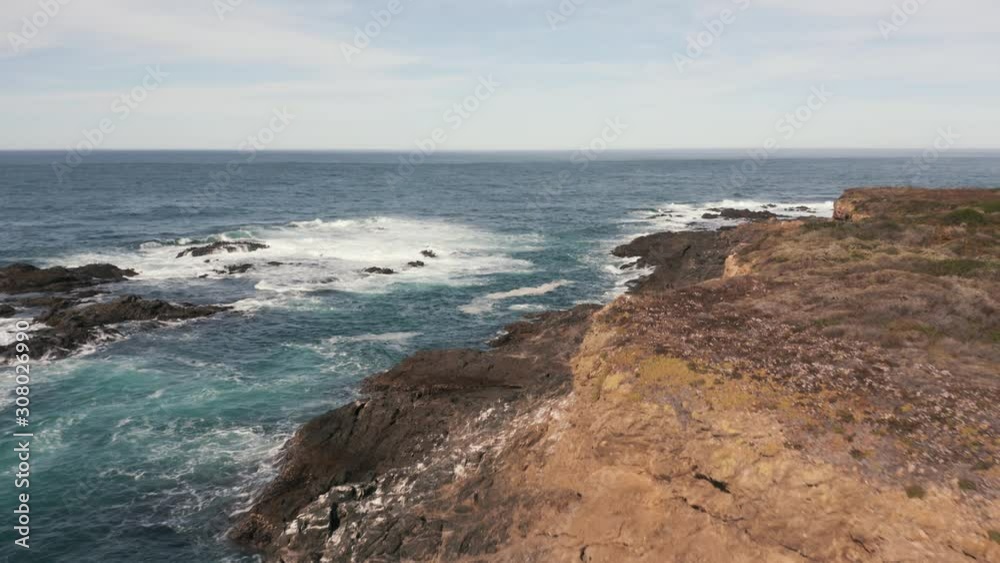 Flying alongside a rocky, cliff laden shoreline. Aerial. Flying alongside a rocky, cliff laden shoreline. Aerial.