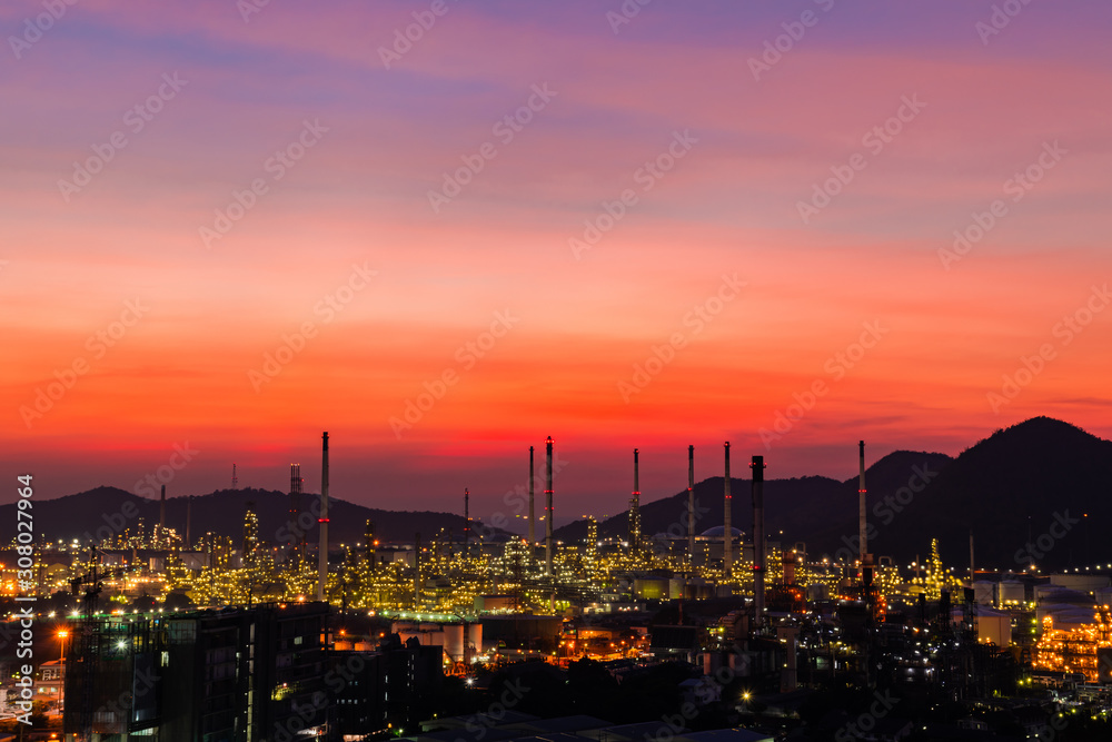 Obraz premium The colorful lights in oil refinery industry power station at night time with Twilight sky ,Chonburi,Thailand.