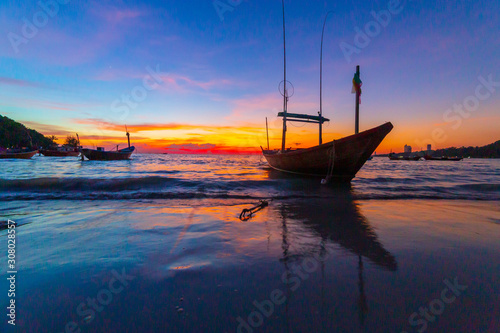 Silhouette of Fishing boat and Fishing equipment. Sunset and Fishing boat at Sea rayong,Thailand.