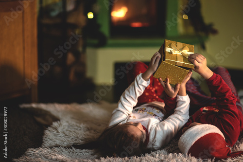 Children open a New Year's gift.