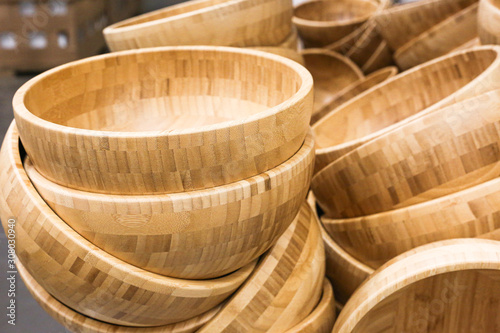 Bamboo wooden bowls for salads laying at the shop. © Maria Kasimova