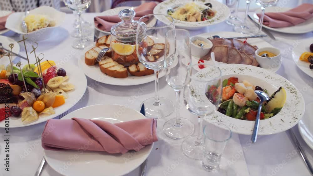 Sliding view of elegant wedding table with delicious dishes and drinks. Sliding view of elegant wedding table with delicious dishes and drinks.