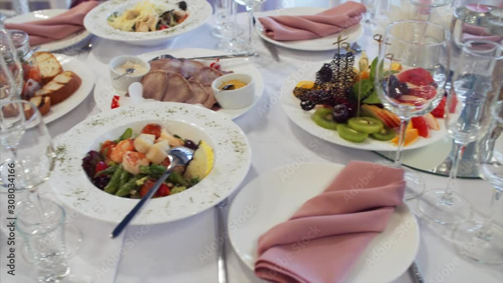 Sliding view of elegant wedding table with tasty dishes and drinks. Sliding view of elegant wedding table with tasty dishes and drinks.