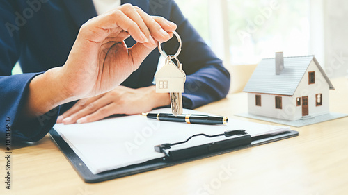 House model with real estate agent and customer discussing for contract to buy house, insurance or loan real estate background. photo