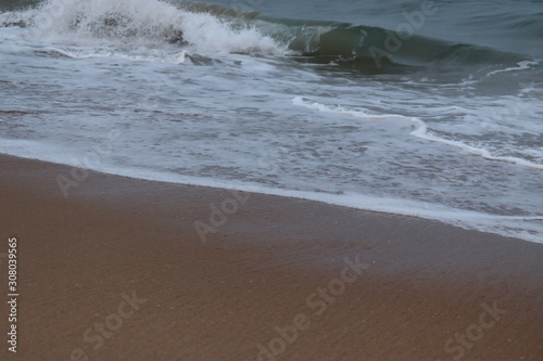 beautiful sand beach.Close up soft wave lapped the sandy beach, Summer Background.