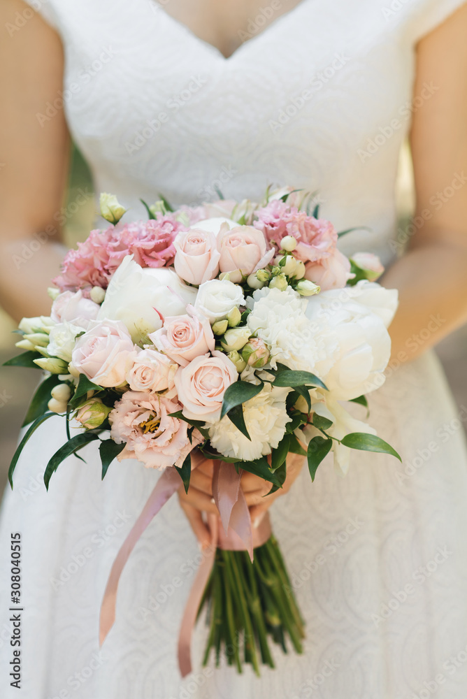 Bridal morning details. Wedding beautiful bouquet in the hands of the bride, selectoin focus