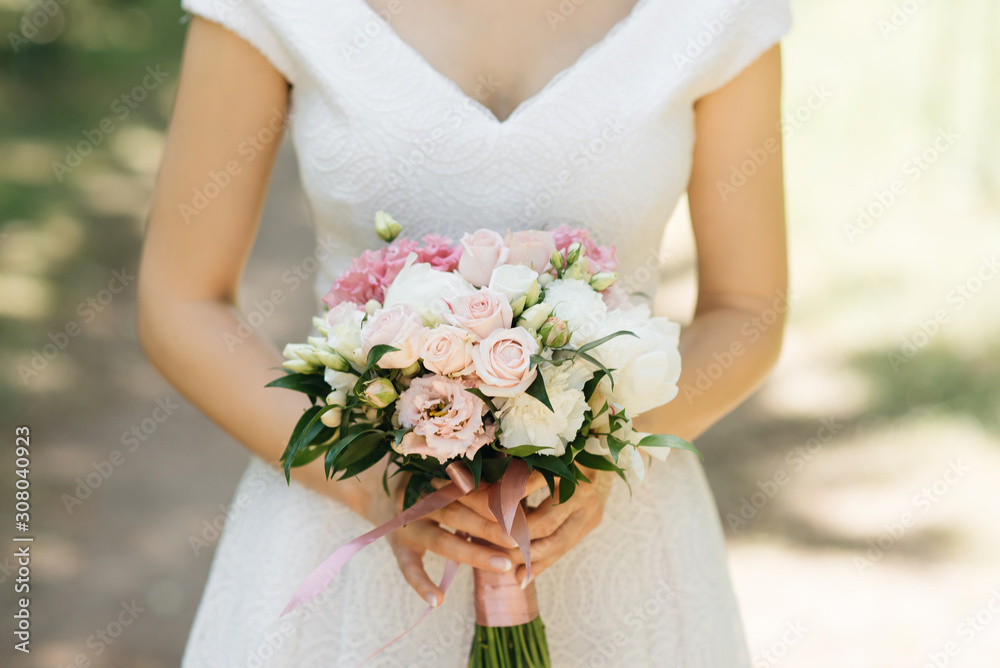 Bridal morning details. Wedding beautiful bouquet in the hands of the bride, selectoin focus Bridal morning details. Wedding beautiful bouquet in the hands of the bride, selectoin focus
