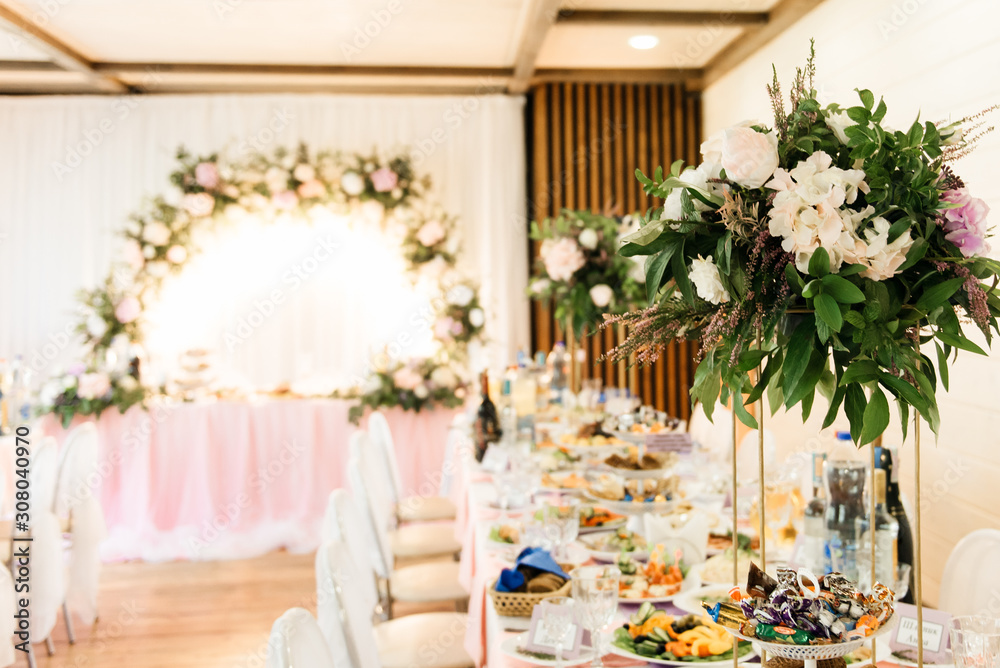 The concept of decor for weddings and holidays, floral arrangements on the table of fresh flowers.  The Presidium of the newlyweds