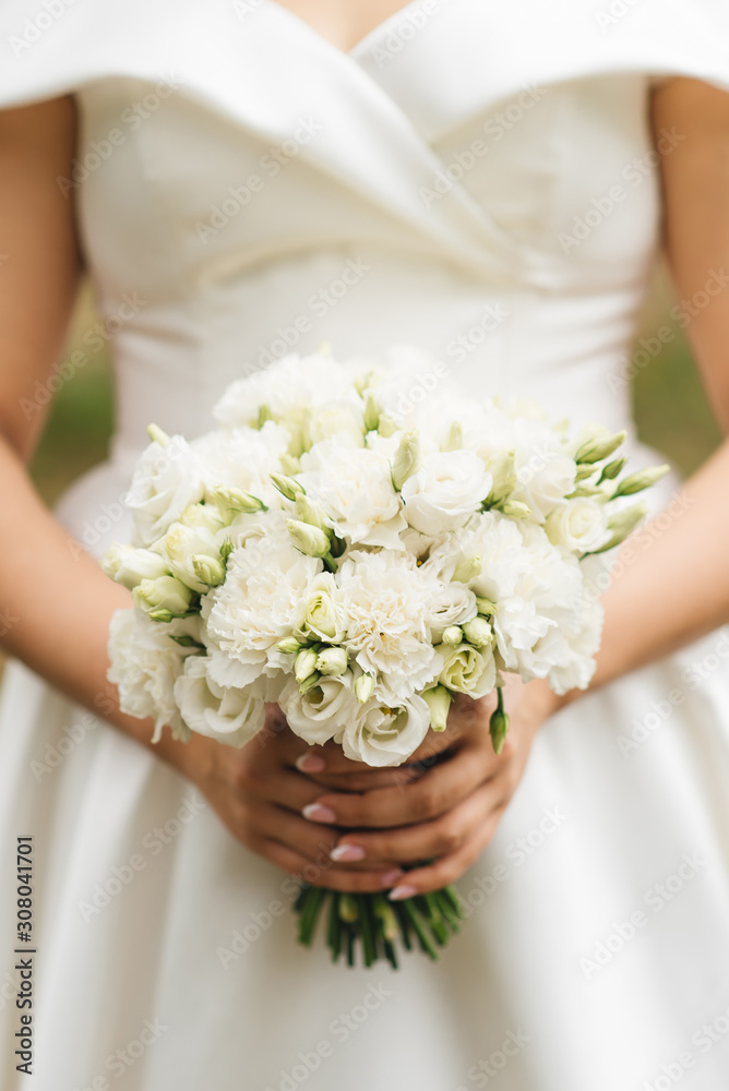 Bridal morning details. Wedding beautiful bouquet in the hands of the bride, selectoin focus