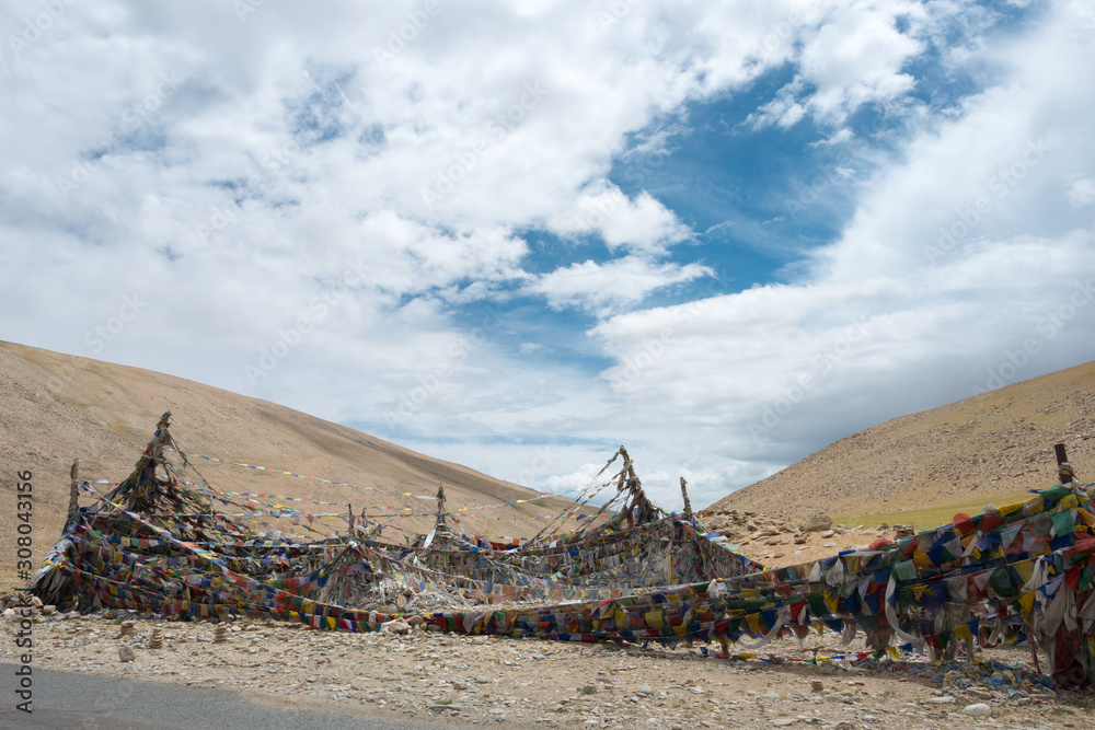Ladakh, India - Jul 12 2019 - Tibetan prayer flag at Kiagar La Pass in Ladakh, Jammu and Kashmir, India. Kiagar La is situated at an altitude of around 4843m above the sea level. Ladakh, India - Jul 12 2019 - Tibetan prayer flag at Kiagar La Pass in Ladakh, Jammu and Kashmir, India. Kiagar La is situated at an altitude of around 4843m above the sea level.
