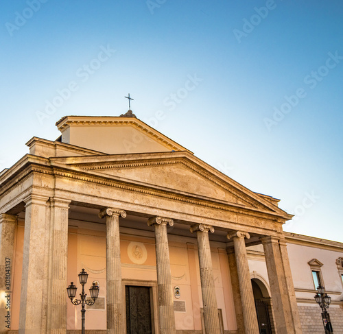 The cathedral of San Pietro Apostolo in Isernia. The facade with a large triangular tympanum in travertine, supported by pillars and columns with Ionic capitals. The portal with bas-reliefs.
