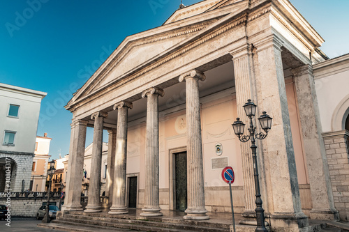 The cathedral of San Pietro Apostolo in Isernia. The facade with a large triangular tympanum in travertine, supported by pillars and columns with Ionic capitals. The portal with bas-reliefs.