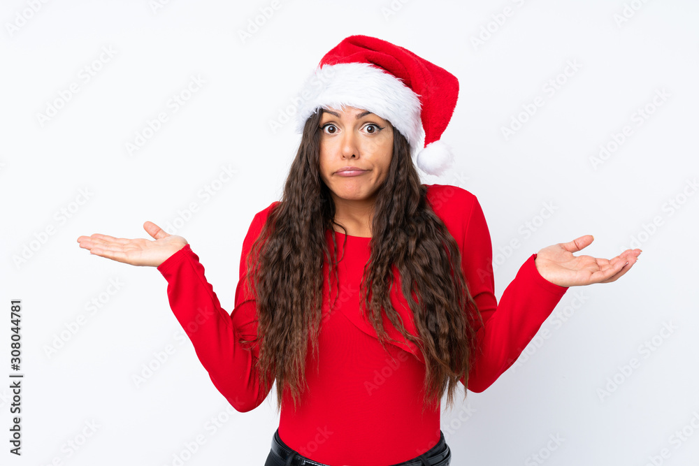 Girl with christmas hat over isolated white background having doubts with confuse face expression Girl with christmas hat over isolated white background having doubts with confuse face expression