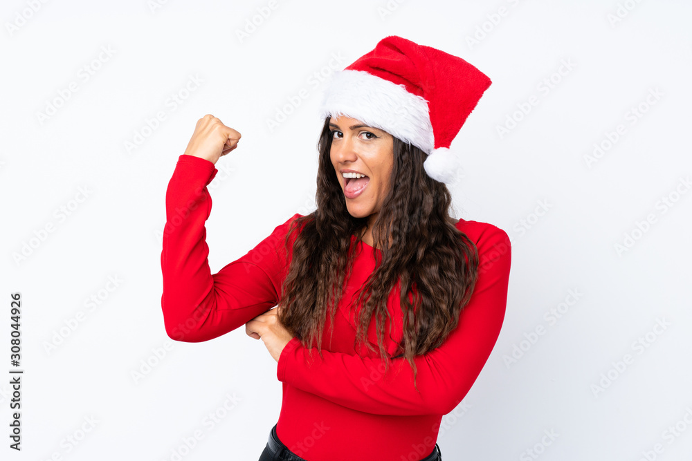 Girl with christmas hat over isolated white background making strong gesture Girl with christmas hat over isolated white background making strong gesture