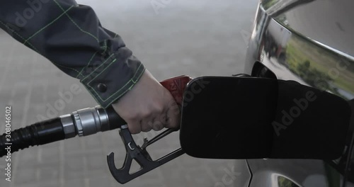 Gas nozzle is getting taken out from car's fuel tank