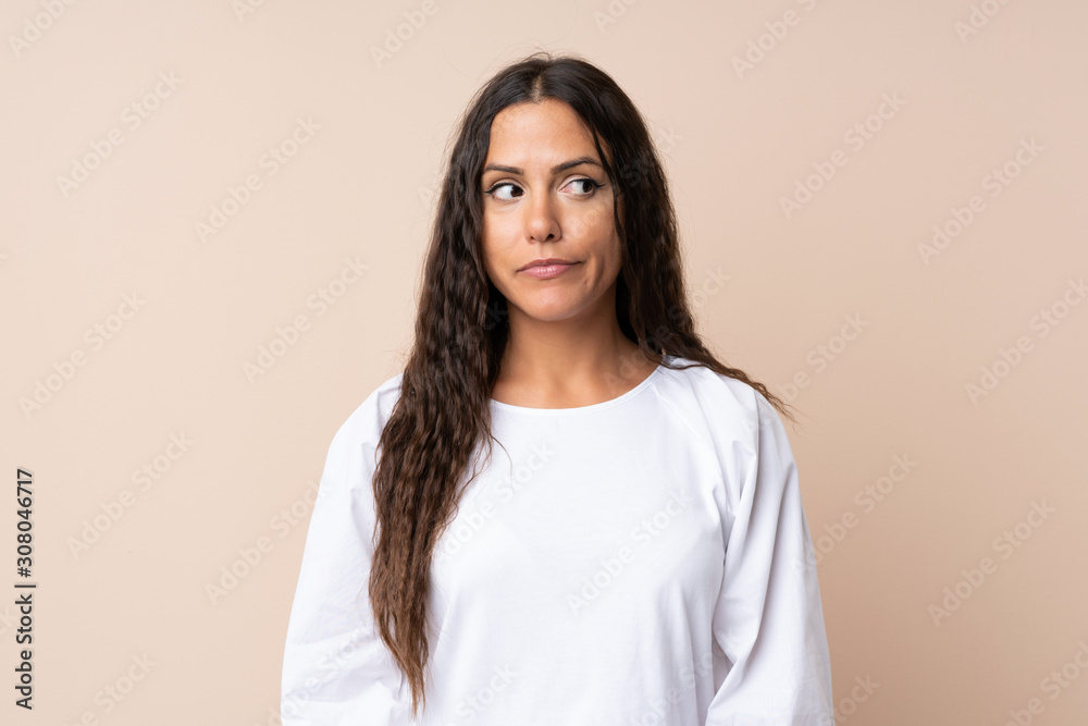 Young woman over isolated background standing and looking to the side Young woman over isolated background standing and looking to the side