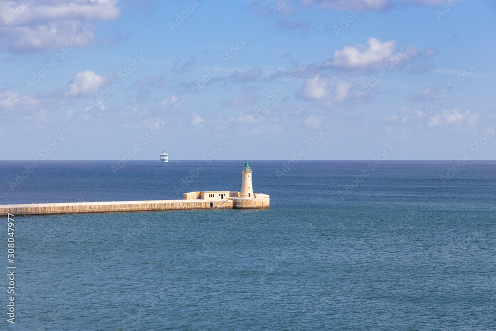 lighthouse in Valette Malta in the mediterranean sea and cruise ship