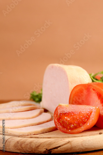 Sliced chicken ham with vegetables.