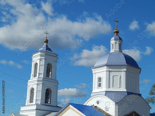 The building of the Orthodox Christian Church. Beautiful golden domes in the blue sky.