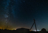 The starry sky and the bright milky way above the village.