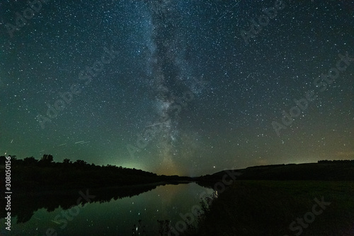 Starry sky and bright milky way over the river.