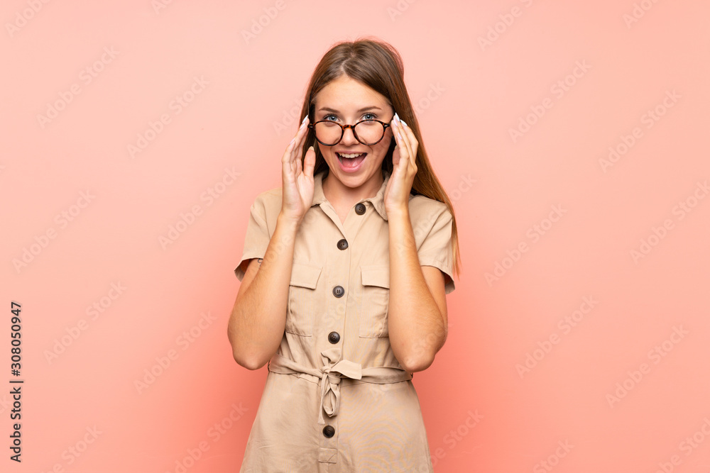 Lithuanian blonde girl over isolated pink background with glasses and surprised Lithuanian blonde girl over isolated pink background with glasses and surprised