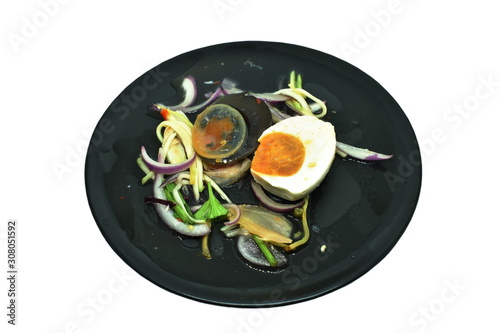 boiled salty and black preserved egg half cut with slice ginger salad on plate