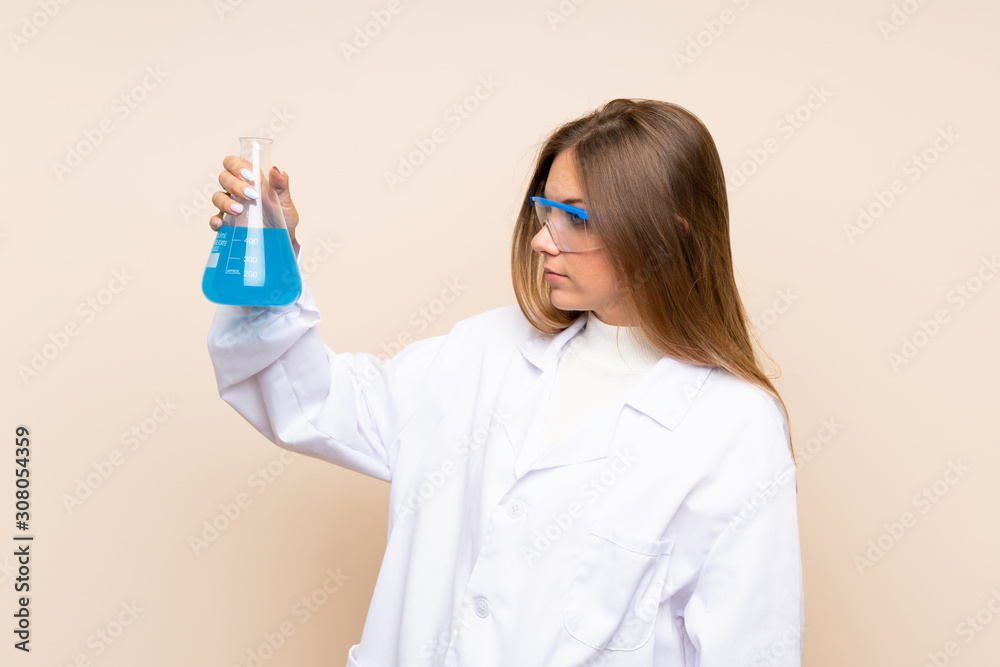 Young blonde woman over isolated background with a scientific test tube Young blonde woman over isolated background with a scientific test tube