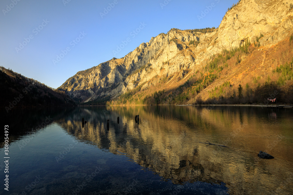 mountain and lake landscape with reflection during autumn at the leopoldsteiner see