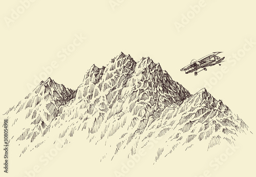 A flight over the mountains. Plane flying over alpine landscape