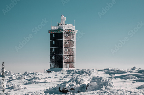 Weather station house building in the snow landscape on a mountain top. Brocken, Harz National Park Mountains in Germany