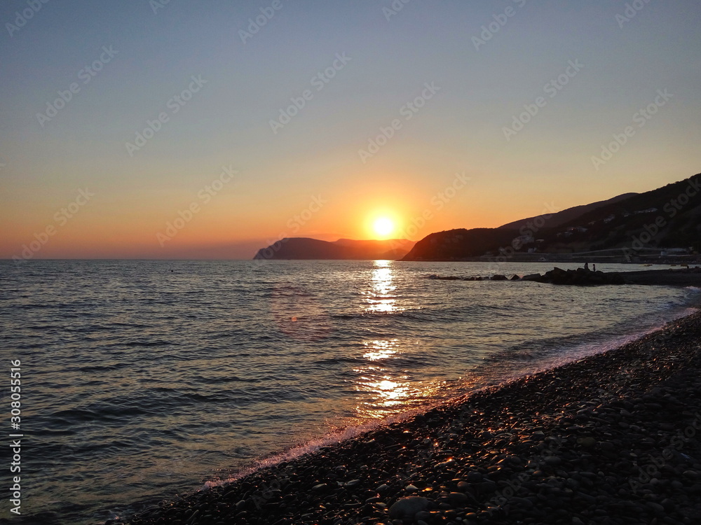 landscape with sea and mountains at orange sunset landscape with sea and mountains at orange sunset