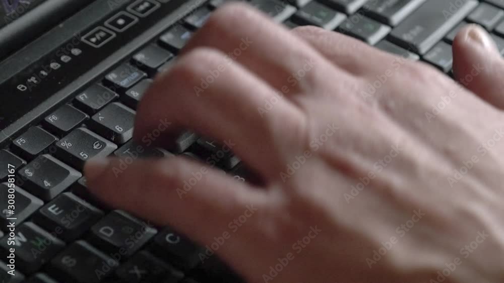 Closeup of a man working and typing text on a laptop computer keyboard. Closeup of a man working and typing text on a laptop computer keyboard.