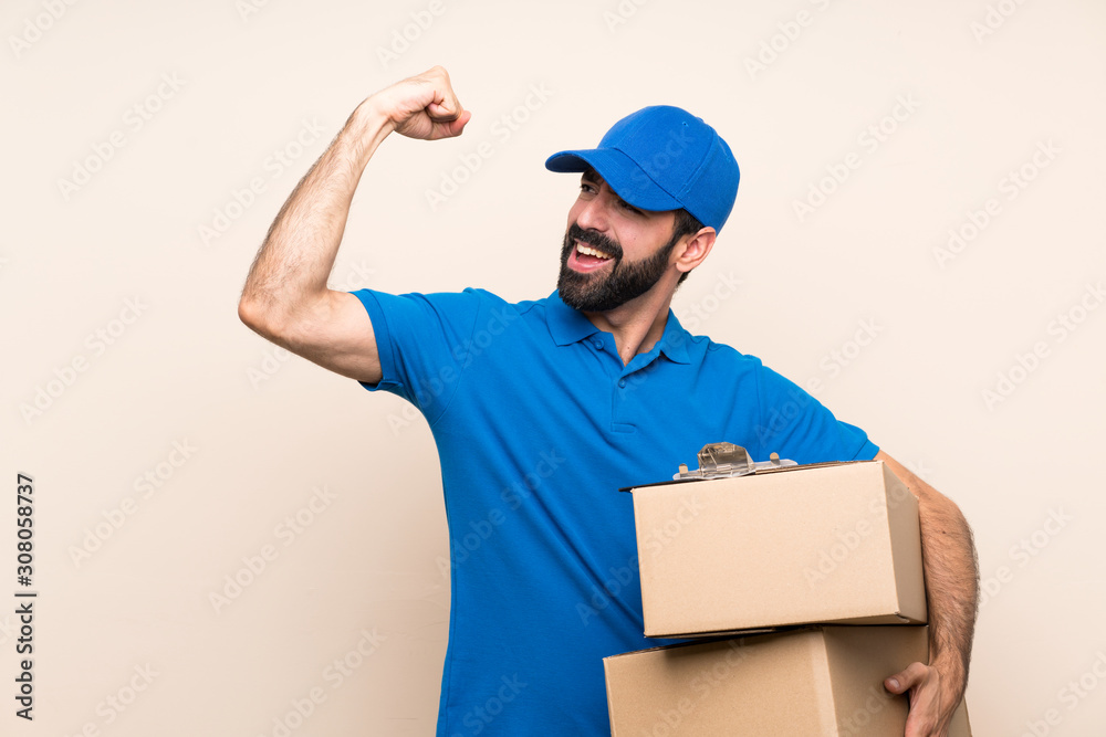 Delivery man with beard over isolated background celebrating a victory Delivery man with beard over isolated background celebrating a victory