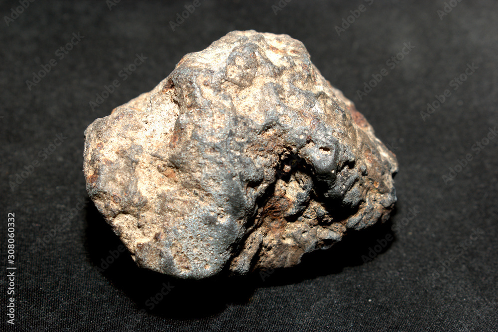 Iron-stone meteorite on a black background Iron-stone meteorite on a black background