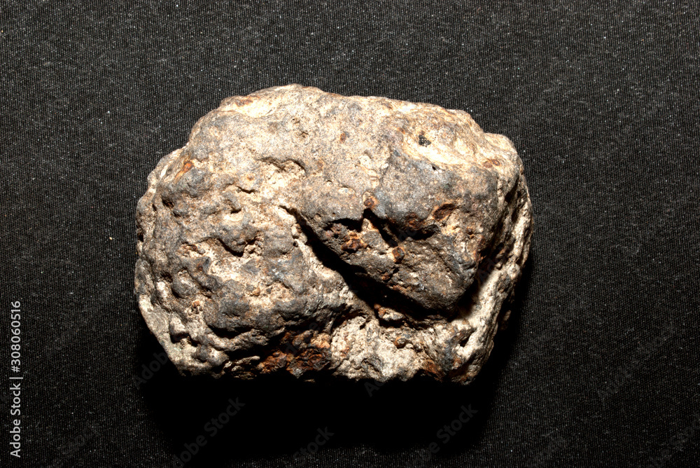 Iron-stone meteorite on a black background
