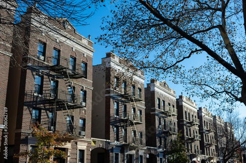 Canvas Print Row of Similar Old Brick Residential Buildings in Astoria Queens New York with F