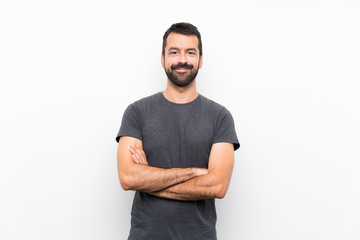 Young handsome man over isolated white background keeping the arms crossed in frontal position