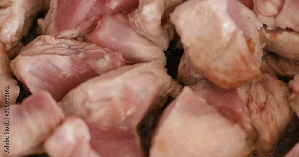 Pork chunks frying at high heat, close-up Pork chunks frying at high heat, close-up