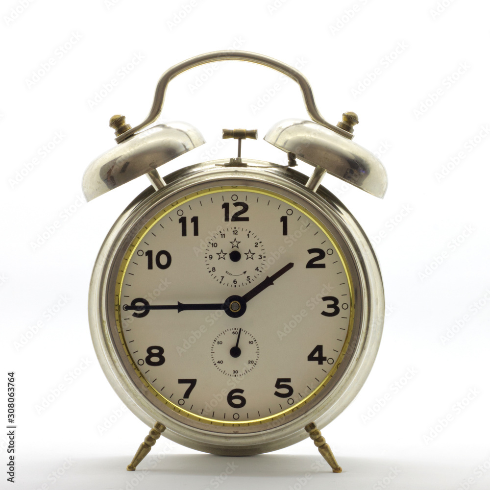 Old-style alarm clock, metal, it's quarter to two. Old-style alarm clock, metal, it's quarter to two.