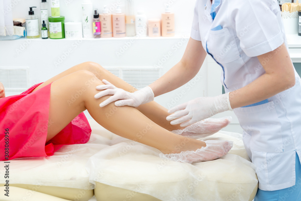 beautician hair removal procedure on the client's feet in beauty parlor beautician hair removal procedure on the client's feet in beauty parlor