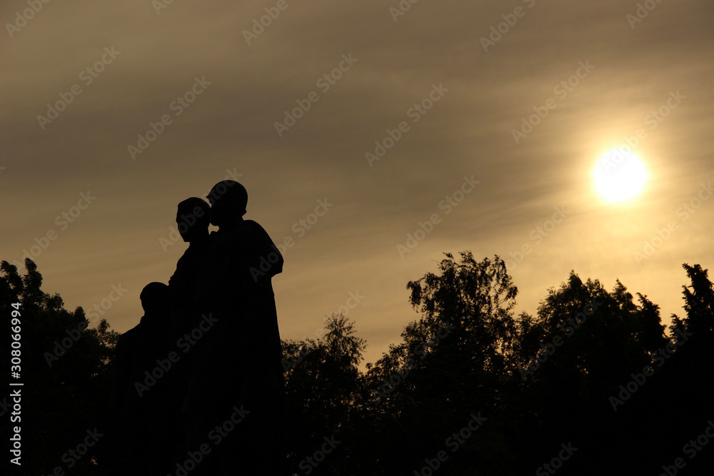 Statues of soviet soldiers at the memorial monument and military cemetery Slavin. Backlights during a golden sunset. Bratislava, Slovakia.