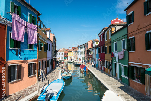 Colourfully painted houses facade on Burano island on sunny day, province of Venice, Italy