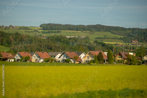 Wooden houses in small town and field in rural area of switzerland for background with copy space
