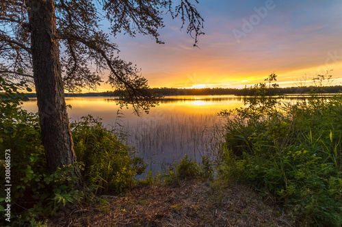 A beautiful sunset view of a calm and peaceful lake in Northwest Ontario, Canada. © Gordon Pusnik
