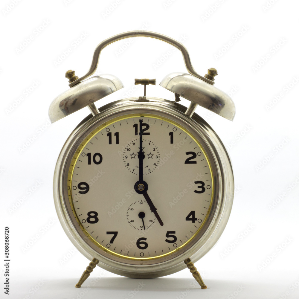 Old-style alarm clock, metal, it's five o'clock. Old-style alarm clock, metal, it's five o'clock.