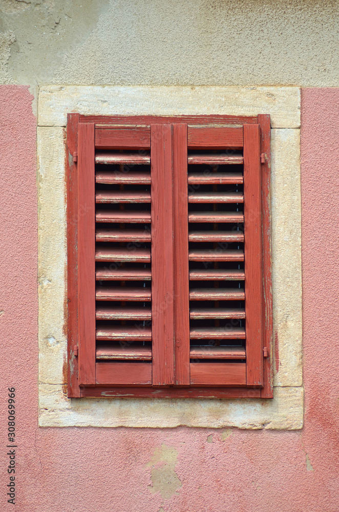 Red window pink old wall isolated