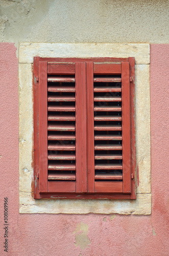 Red window pink old wall isolated